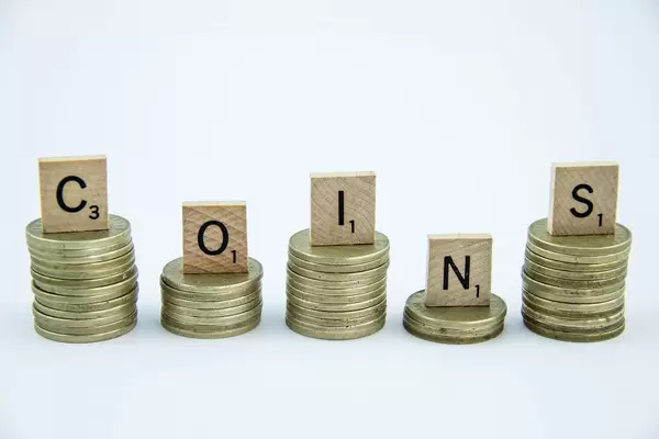 Letters on top of Coins reading COINS