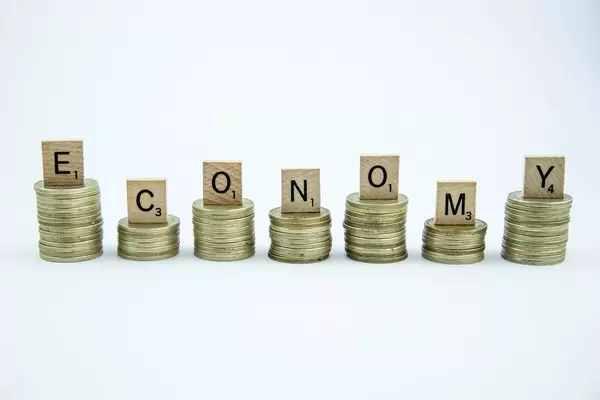Letters on top of Coins reading ECONOMY