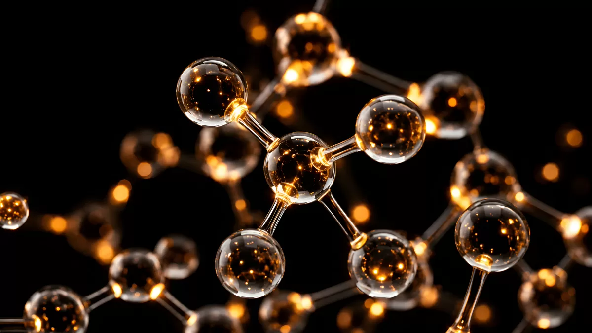 Leuchtendes Molekülmodell aus Glas auf schwarzem Grund
