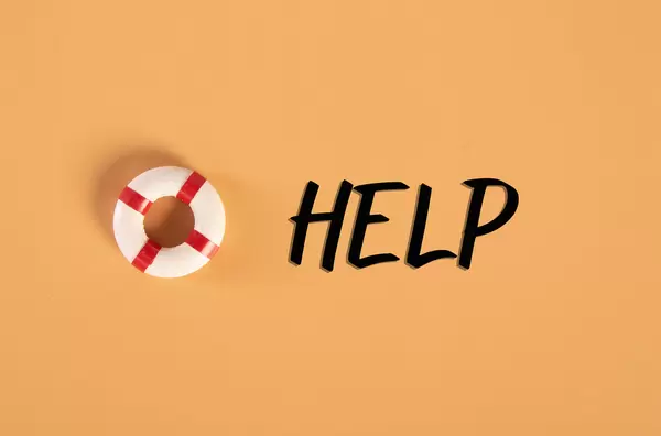 Lifebuoy with Help text on orange background