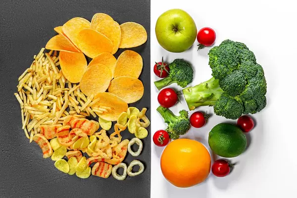 Lifestyle choice concept. Healthy food on white and junk food on a black background. Top view (Flip 2019)