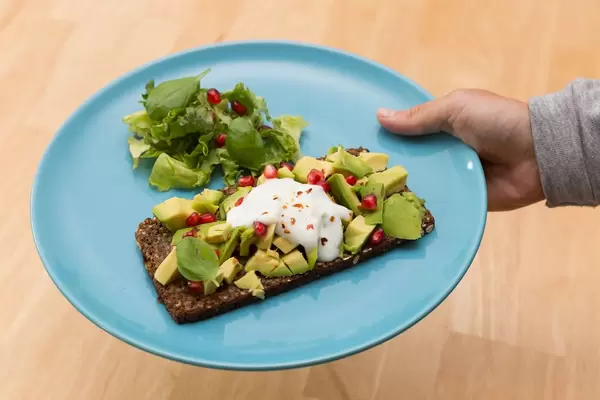 Light and healthy Meal: Avocado Sandwich with Salad and Pomegranate