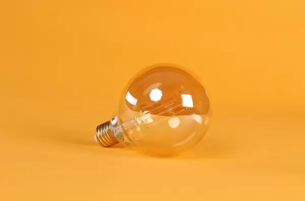 Light bulb on orange background