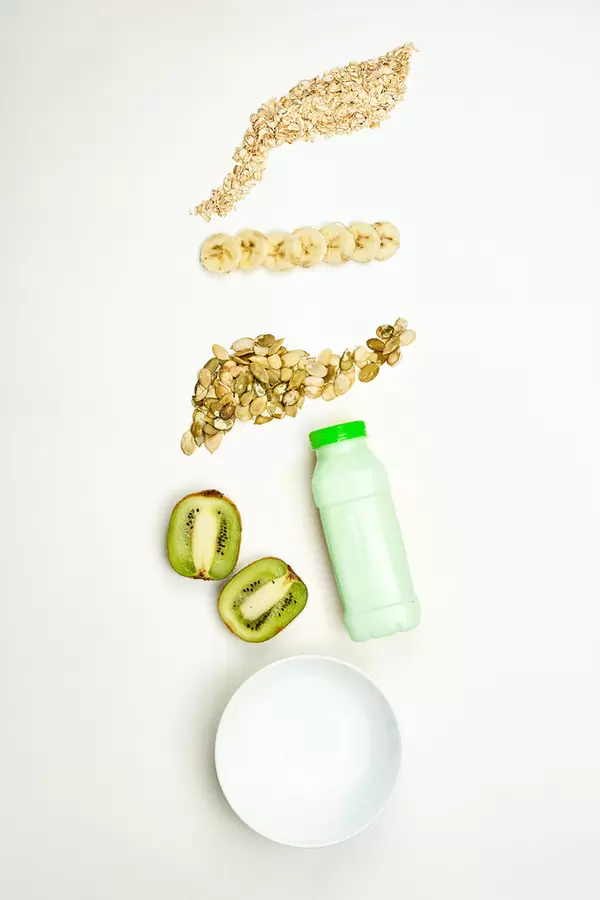 Light fasting food with banana, kiwi fruits, pumpkin seeds and oatmeal