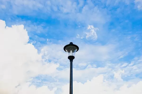 Light post with cloudy sky background
