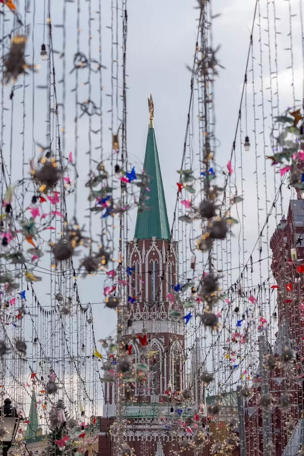 Lights and decoration at Nikolskaya Street with Kremlin tower with a ruby Soviet star in the background