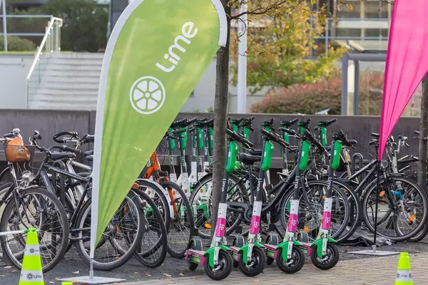 Lime Scooters parked with Telekom branding at Digital X in Cologne