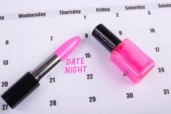 Lipstick and nail polish with Date Night text on the calendar