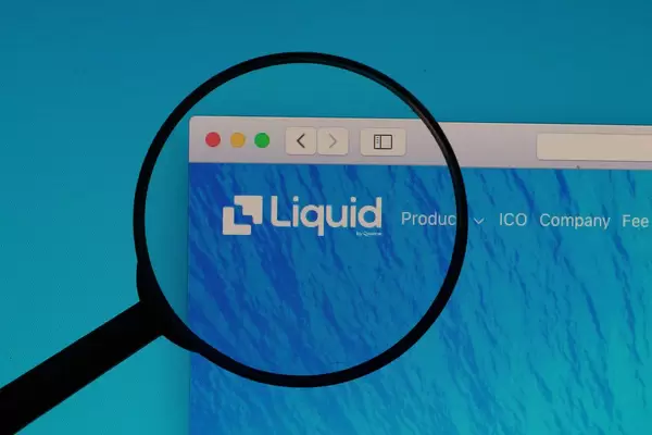 Liquid logo under magnifying glass