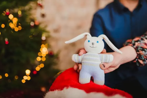 Little Christmas Bunny Toy With Lights On Background