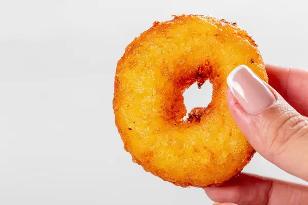 Little fried donut in hand in woman (Flip 2019)