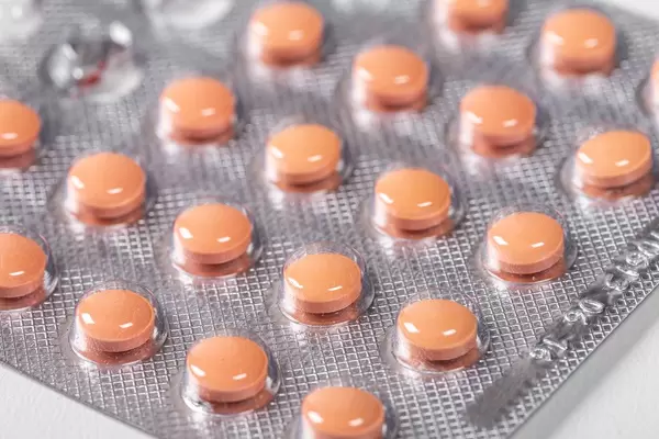 Little pink pills in a blister pack (Flip 2019)