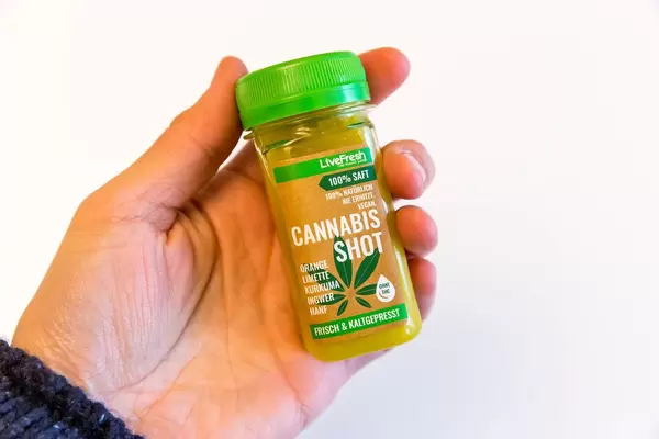 Livefresh Cannabis Shot fresh and cold-pressed in the hand on white background