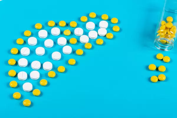 Liver diseases and their treatment concept. Liver made from pills on blue