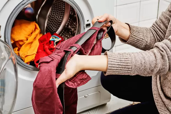 Loading colored clothes in washing machine