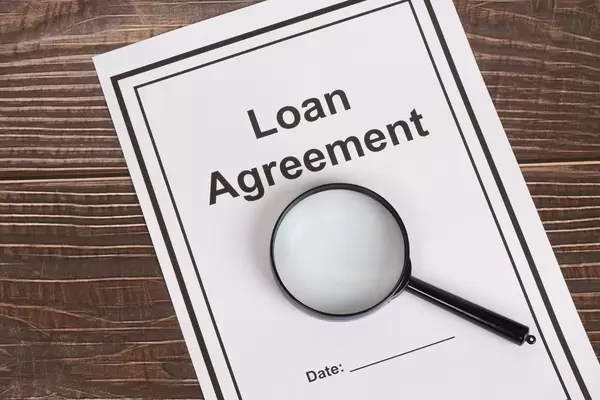 Loan Agreement document with magnifying glass