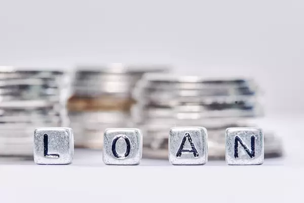 Loan and stack of silver coins. Financial concept