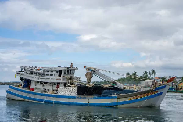 Local Fishermen on a Fishing Boat returning to the Harbour after fishing Anchovies for making Fish Sauce on Phu Quoc Island, Vietnam