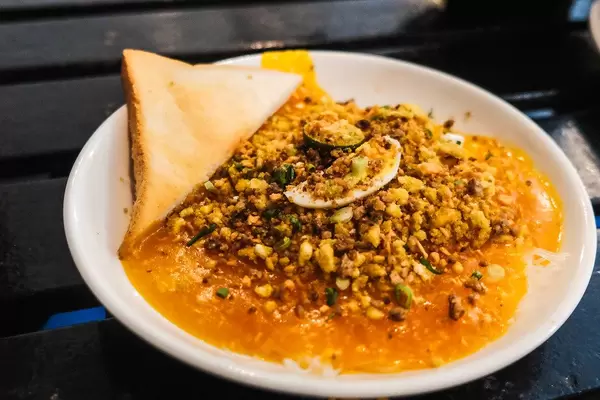 Local palabok served with bread on black table