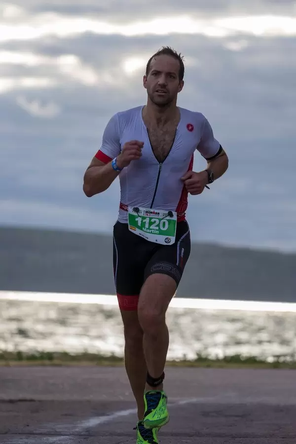 Long-distance runner during the Ironman 70.3 half marathon at the Finnish coast of Vesijärvi in Lahti