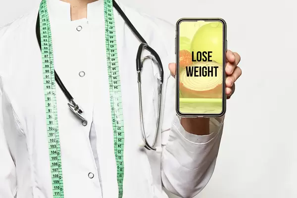 Lose weight concept. Dietitian with smartphone