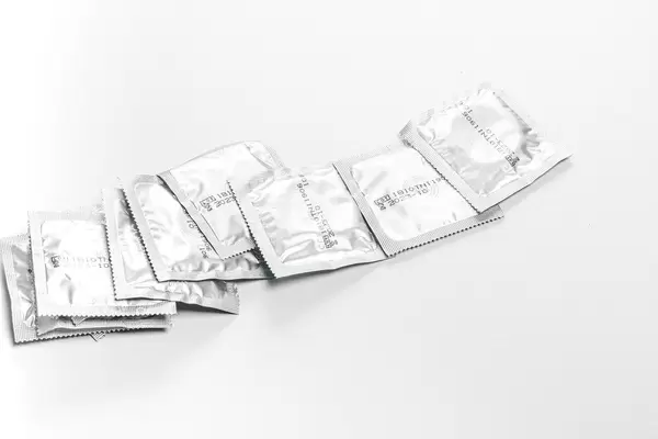 Lot of sealed condoms. The concept of contraception, the fight against AIDS