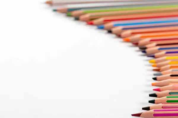 Lots of colorful pencils on white background with free space