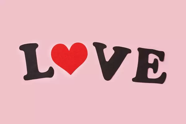 Love text made of red heart and paper cuts