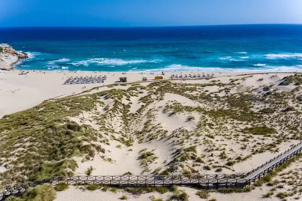 Luftaufnahme eines langen Holzweges in den Dünen am Strand von Cala Mesquida, Mallorca, Spanien