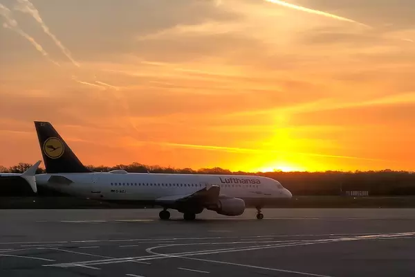 Lufthansa airplane on an airport runway at sunset