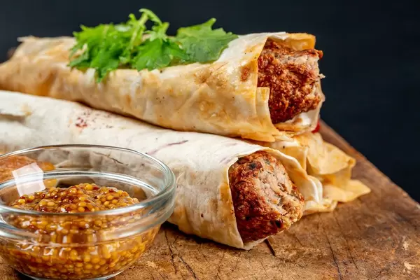 Lulia kebab in pita bread and mustard sauce, close-up