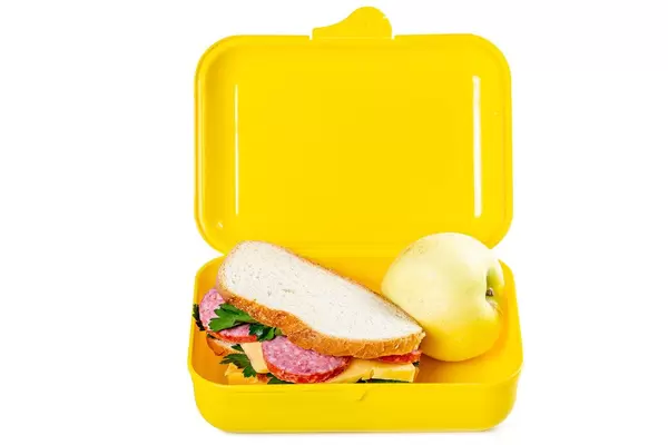 Lunch box with sandwich and apple on white background