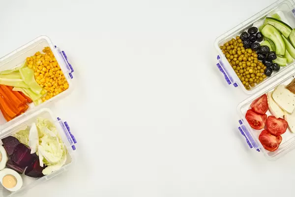 Lunchboxes with dieting meal on two sides and copy space in the middle