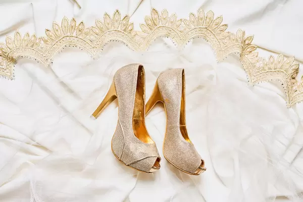 Luxury bridal shoes on wedding dress