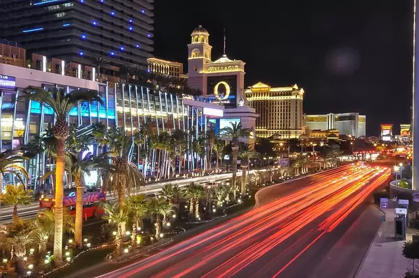 Luxushotels am beleuchteten Las Vegas Boulevard, mit Palmen und schwarzem Himmel