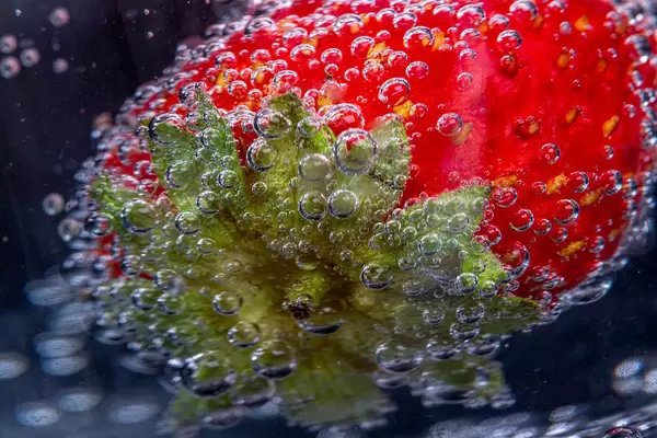 Macro photography of strawberry berries covered with air bubbles