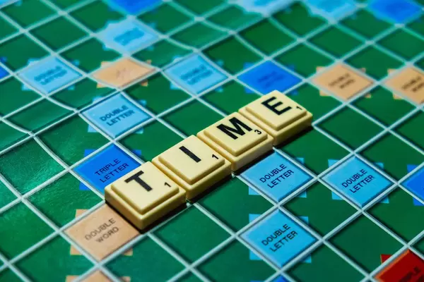 Macro shot of "Time" word on scrabble board