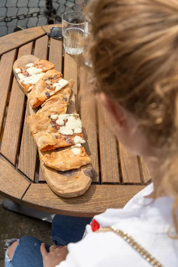 Mädchen betrachtet Knoblauchbrot auf dem Tisch