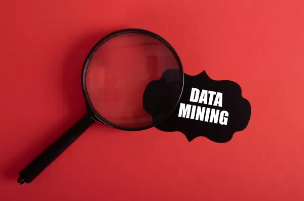 Magnifier and black sticker with Data Mining text on red background