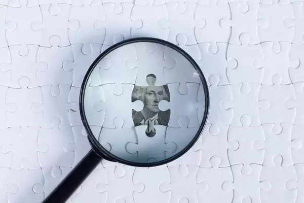 Magnifier and puzzle on money