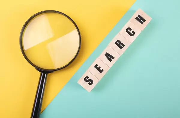 Magnifier and wooden blocks with Search text