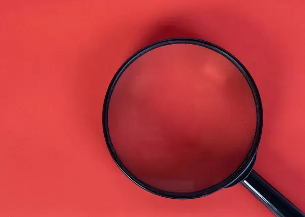 Magnifier glass on red background