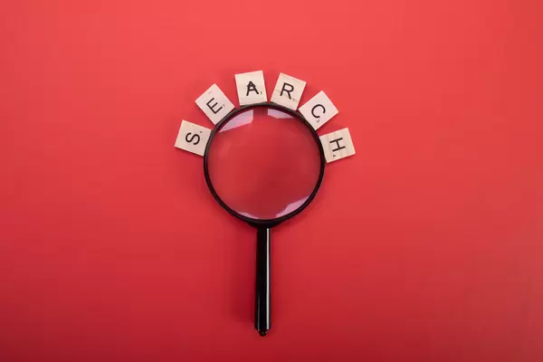 Magnifier with Search text on red background