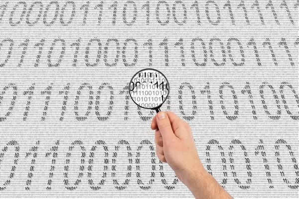 Magnifying glass and binary code