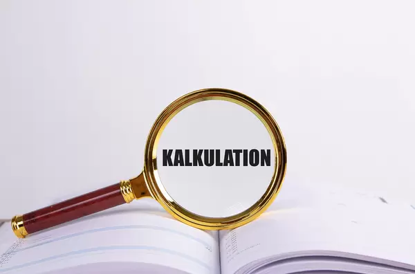 Magnifying glass and book with Kalkulation text