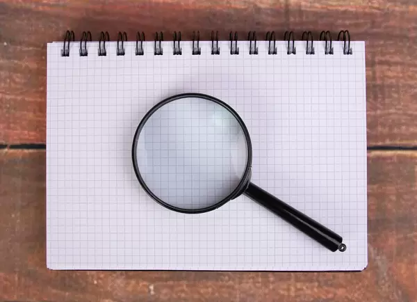 Magnifying glass on notepad