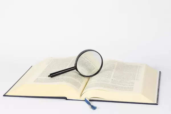 Magnifying glass on open book