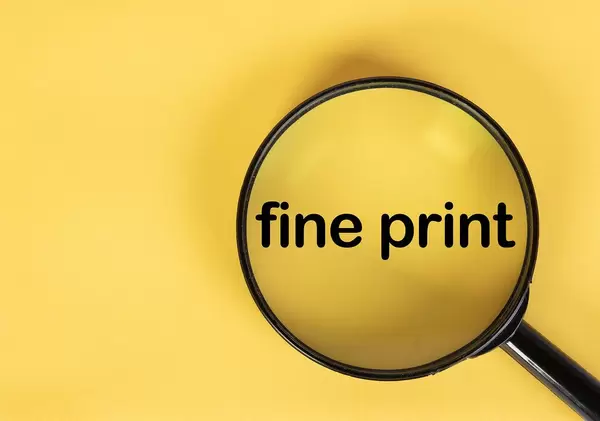 Magnifying glass over fine print text