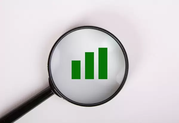 Magnifying glass over green chart