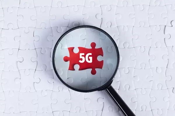 Magnifying glass over missing puzzle with a text 5G